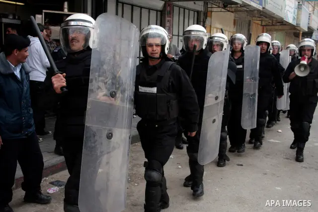 Palestinian security forces block the way of Hamas demonstrators who were trying to reach an Israeli-controlled checkpoint in the West Bank city of Hebron following a rally to mark the 63th anniversary of "Nakba" (catast...