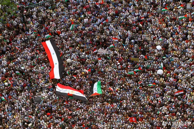 Egyptian demonstrators wave Palestinian flags and Egyptian flags during a rally at Cairo's Tahrir Square on May 13, 2011 during a protest calling for national unity after attacks on Egyptian churches, and solidarity with...