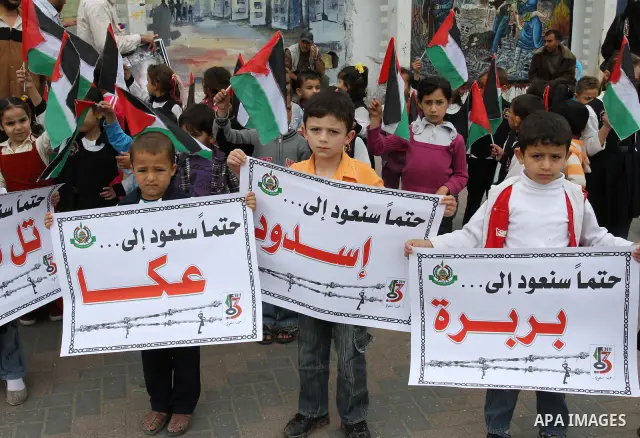 Palestinian children take part in a rally marking the 63rd anniversary of the 'Nakba', or 'Catastrophe', in Gaza City, Saturday, May 14, 2011. Hundreds of thousands of Palestinians were uprooted in the 1948 war that led...