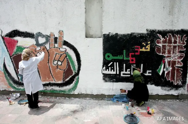 Palestinian Artists take part in paint a murals to mark the 63th anniversary of "Nakba" (catastrophe), in Gaza City, on May 14, 2011. Hundreds of thousands of Palestinians were uprooted in the 1948 war that led to Israel...