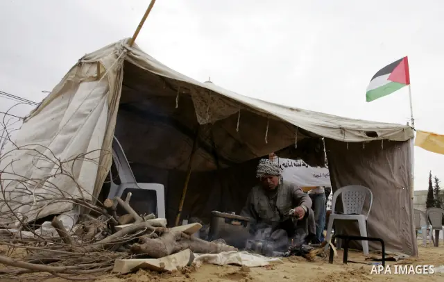 Palestinian men gather at the "Camp of Return" tent to stress the refugees' ties to their ancestral land on May 14, 2011 in the southern Gaza Strip refugee camp of Rafah, where Palestinians are marking the 63rd anniversa...