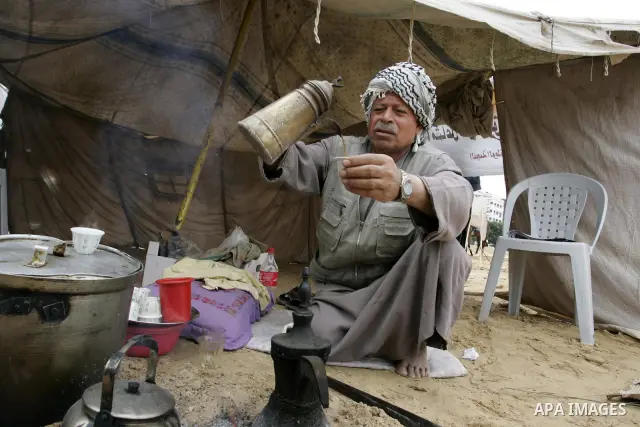Palestinian men gather at the "Camp of Return" tent to stress the refugees' ties to their ancestral land on May 14, 2011 in the southern Gaza Strip refugee camp of Rafah, where Palestinians are marking the 63rd anniversa...