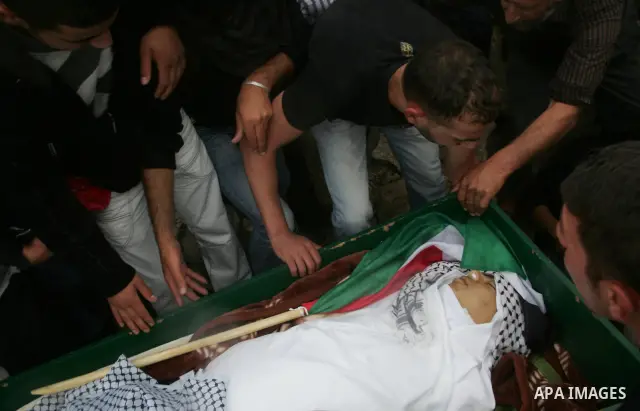 Mourners carry the body of Milad Ayyash, a Palestinian teenager who died after being shot as Palestinians launched events to mourn the 1948 creation of the Jewish state in Jerusalem the day before, during his funeral pro...