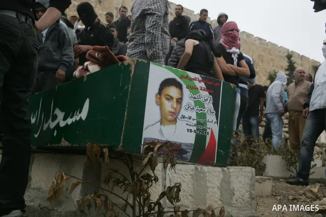 Mourners carry the body of Milad Ayyash, a Palestinian teenager who died after being shot as Palestinians launched events to mourn the 1948 creation of the Jewish state in Jerusalem the day before, during his funeral pro...