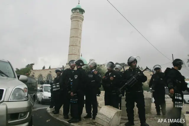 Israeli riot police stand guard during clashes with Palestinian youths following the funeral of a teenager who died after being shot as Palestinians launched events to mourn the 1948 creation of the Jewish state in Jerus...