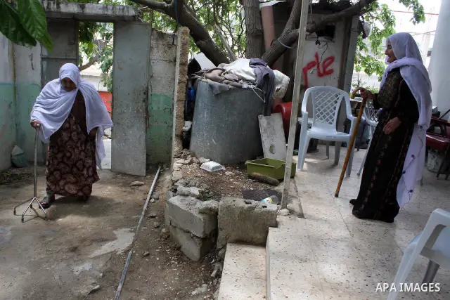 Palestinian refugees stand and holding a key in the Al-Aroub refugee camp near Hebron, on May 14 , 2011 after they was expelled from there original home in 1948. Palestinians commemorate the 63rd anniversary of Nakba, or...