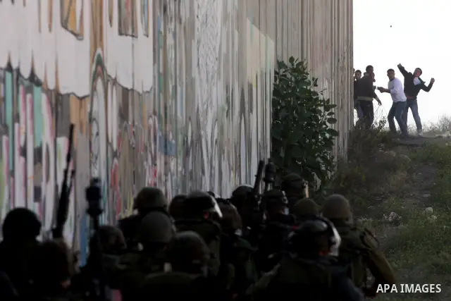 Palestinian youth hurl stones during clashes with Israeli soldiers at the Israeli manned Qalandia checkpoint between Jerusalem and the West Bank city if Ramallah on May 14, 2011, as Palestinians gather in the runup to to...