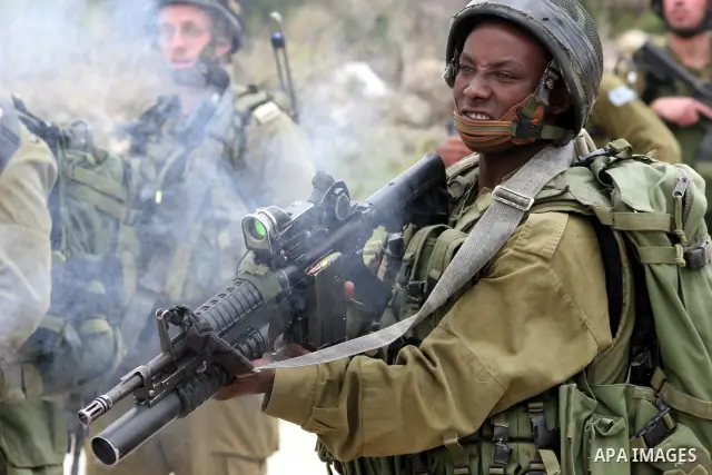 Israeli soldiers shoot the youths Palestinian during clashes in the West Bank city of Hebron on May 15, 2011, while Palestinians mourned on May 15, 2011 the "nakbah" anniversary of Israel's creation in 1948, as a result...