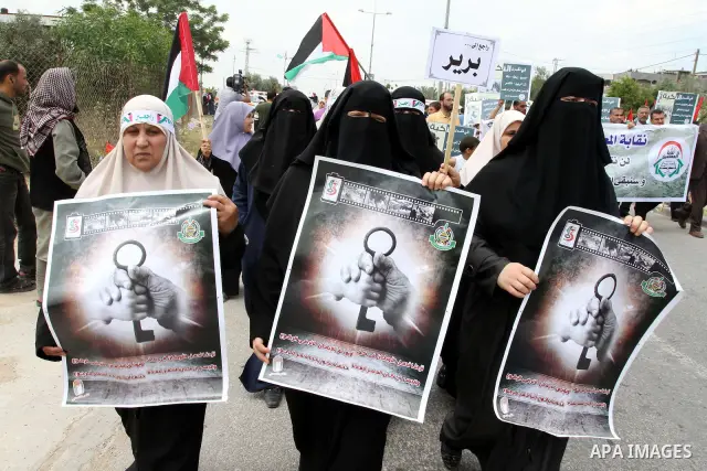Palestinian protesters wave Palestinian national flags during a demonstration in front of the Erez border crossing in the northern Gaza Strip, on May 15, 2011, as people gathered to mark the "nakbah" or "catastrophe" ann...
