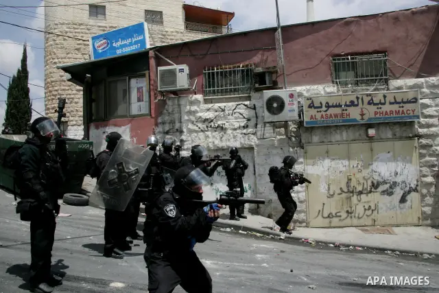 Israeli riot and undercover policemen take position during clashes with Palestinian protesters in the east Jerusalem Arab neighborhood of Issawiya on May 15, 2011 while heavy clashes broke out near Ramallah in the West B...