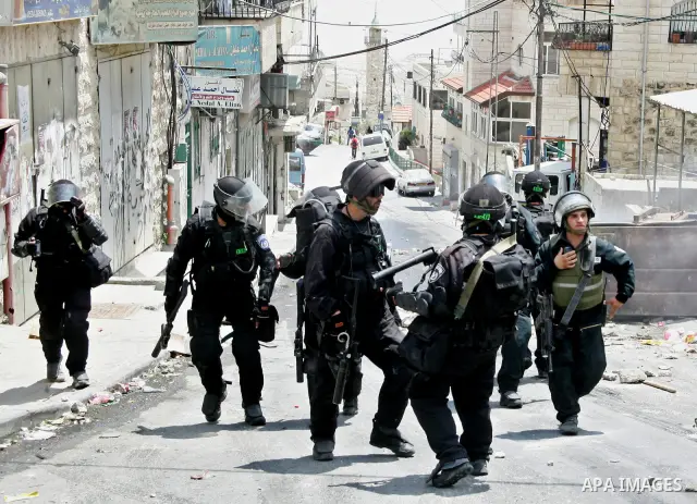 Israeli riot and undercover policemen take position during clashes with Palestinian protesters in the east Jerusalem Arab neighborhood of Issawiya on May 15, 2011 while heavy clashes broke out near Ramallah in the West B...