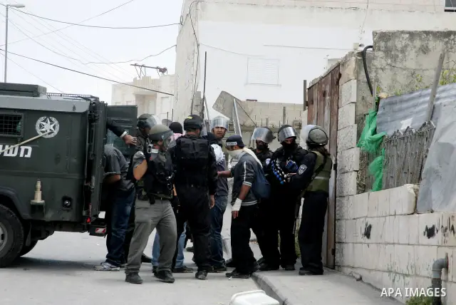 Israeli riot and undercover policemen take position during clashes with Palestinian protesters in the east Jerusalem Arab neighborhood of Issawiya on May 15, 2011 while heavy clashes broke out near Ramallah in the West B...