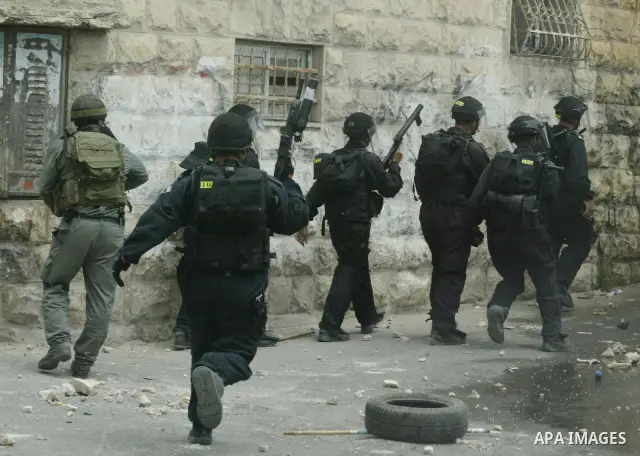 Israeli riot and undercover policemen take position during clashes with Palestinian protesters in the east Jerusalem Arab neighborhood of Issawiya on May 15, 2011 while heavy clashes broke out near Ramallah in the West B...