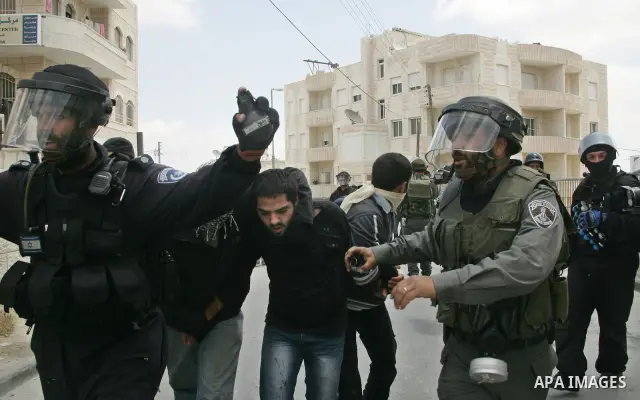 Israeli riot and undercover policemen arrest a Palestinian protester during clashes in the east Jerusalem Arab neighborhood of Issawiya on May 15, 2011 while heavy clashes broke out near Ramallah in the West Bank when yo...