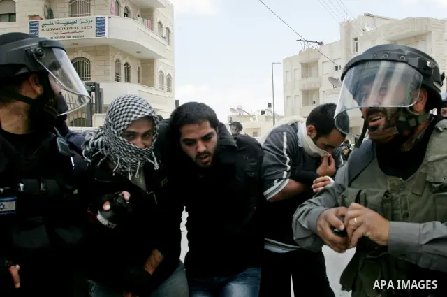 Israeli riot and undercover policemen arrest a Palestinian protester during clashes in the east Jerusalem Arab neighborhood of Issawiya on May 15, 2011 while heavy clashes broke out near Ramallah in the West Bank when yo...