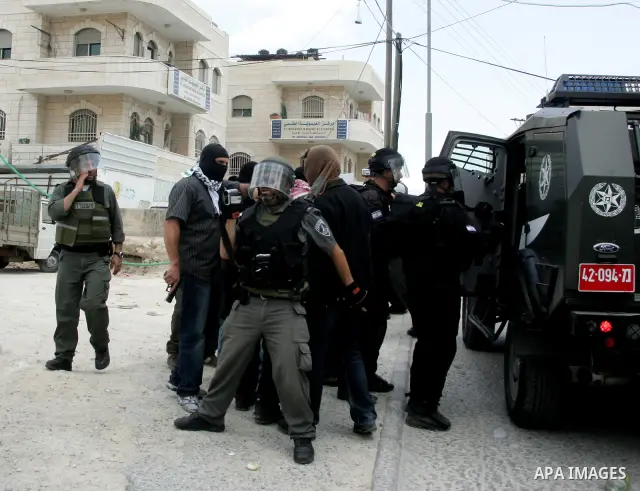 Israeli riot and undercover policemen arrest a Palestinian protester during clashes in the east Jerusalem Arab neighborhood of Issawiya on May 15, 2011 while heavy clashes broke out near Ramallah in the West Bank when yo...