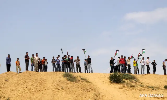 Palestinian protesters march towards the Erez border crossing in the northern Gaza Strip on May 15, 2011 to mark the "Nakba" or "Catastrophe" anniversary of Israel's creation in 1948, as a result of which more than 760,0...