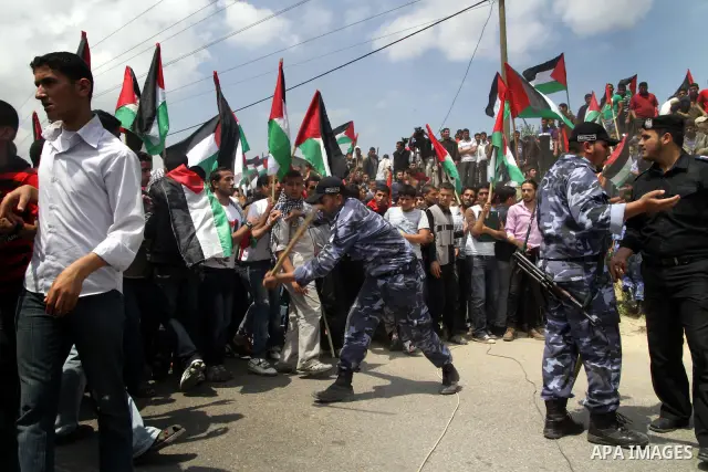Members of Hamas' security forces holds back protesters from reaching Erez border crossing in the northern Gaza Strip, on May 15, 2011, as people gathered to mark the "nakbah" or "catastrophe" anniversary of Israel's cre...