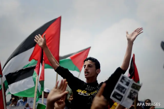 Protesters wave Palestinian flags as they march towards the Erez border crossing in the northern Gaza Strip on May 15, 2011 to mark the "Nakba" or "Catastrophe" anniversary of Israel's creation in 1948, as a result of wh...
