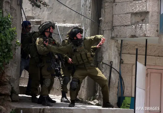 Israeli soldiers fire tear gas canisters during clashes with stone throwers at the Israeli manned Qalandia checkpoint between Jerusalem and the West Bank city of Ramallah on May 15, 2011. Palestinians across the Israeli...