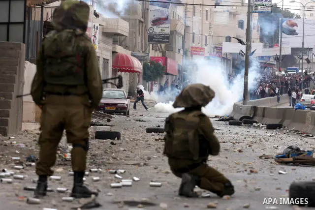 Israeli soldiers fire tear gas canisters during clashes with stone throwers at the Israeli manned Qalandia checkpoint between Jerusalem and the West Bank city of Ramallah on May 15, 2011. Palestinians across the Israeli...