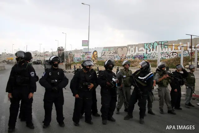 Israeli soldiers take position during clashes with stone throwers at the Israeli manned Qalandia checkpoint between Jerusalem and the West Bank city of Ramallah on May 15, 2011. Palestinians across the Israeli occupied t...