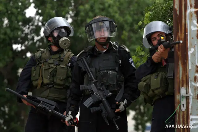 Israeli soldiers take position during clashes with stone throwers at the Israeli manned Qalandia checkpoint between Jerusalem and the West Bank city of Ramallah on May 15, 2011. Palestinians across the Israeli occupied t...