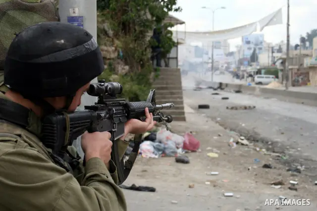 Israeli soldiers fire tear gas canisters during clashes with stone throwers at the Israeli manned Qalandia checkpoint between Jerusalem and the West Bank city of Ramallah on May 15, 2011. Palestinians across the Israeli...