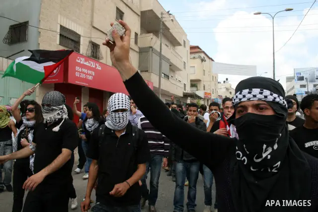 Palestinians march towards the Israeli manned Qalandia checkpoint between Jerusalem and the West Bank city of Ramallah on May 15, 2011. Palestinians across the Israeli occupied territories rallied to mark the 63rd annive...