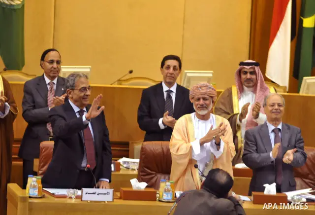 Qutgoing Arab League secretary general Amr Mussa (C) stands up as delegates give him a standing ovation during his last meeting as the league's chief at the Arab League headquarters in Cairo on May 15, 2011. Photo by Ahm...