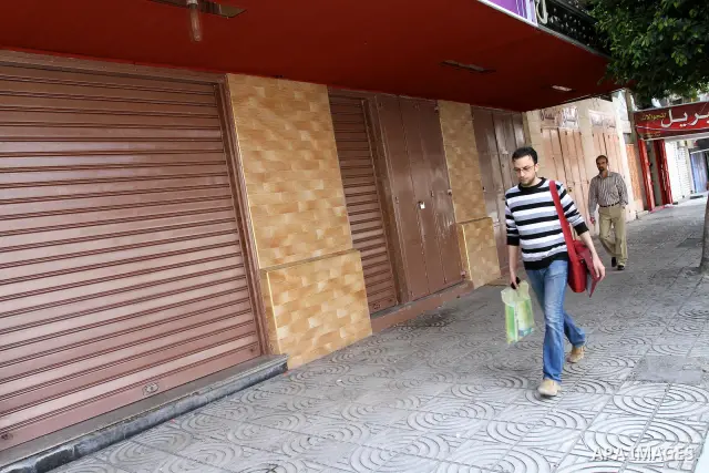 Palestinians walk passed closed shops during a general strike in Gaza Strip on May 16, 2011, to mourn for what israeli occupation done yesterday of shedding the blood of the citizens and Suppression rights of journalists...