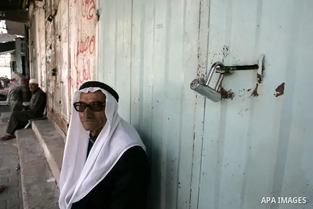 Palestinians walk passed closed shops during a general strike in the southern Gaza Strip town of Rafah on May 16, 2011, to mourn for what israeli occupation done yesterday of shedding the blood of the citizens and Suppre...