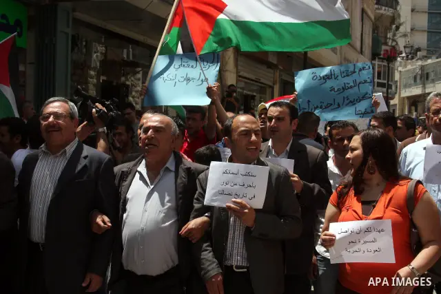 Palestinians in the West Bank city of Ramallah carry a mock coffin during a symbolic funeral on May 16, 2011 for those killed during clashes which erupted as Palestinians and Arab Israelis demonstrated to mark the annive...