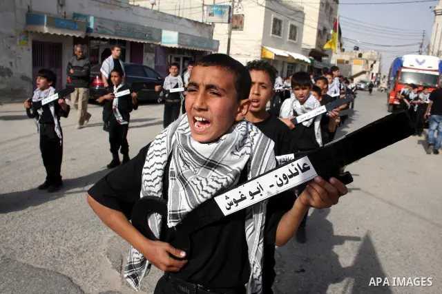 Palestinian boys hold symbolic keys as they take part in a rally marking "Nakba" in the West Bank city of Ramallah May 16, 2011. Palestinians mark the "Nakba", or "catastrophe", on Sunday to commemorate the expulsion or...