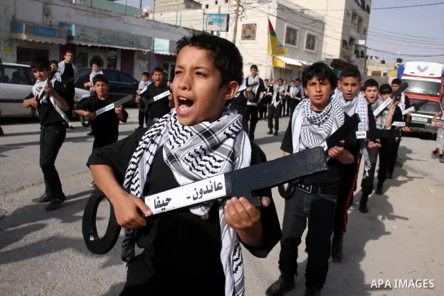 Palestinian boys hold symbolic keys as they take part in a rally marking "Nakba" in the West Bank city of Ramallah May 16, 2011. Palestinians mark the "Nakba", or "catastrophe", on Sunday to commemorate the expulsion or...