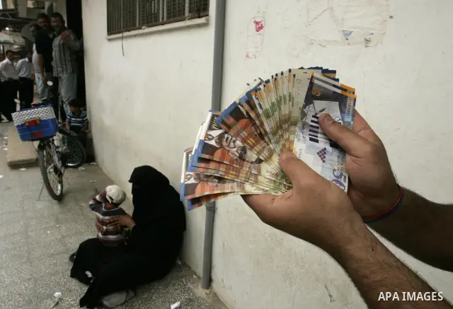 Palestinians employees received their salaries for the month of May through ATMs banks in Rafah in the southern Gaza Strip on May 17, 2011, Where Palestinian Authority delayed to pay salaries for this month after Israel...