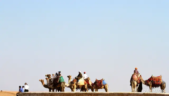 Foreign tourists ride Sentences near the Giza Pyramids at the outskirts of Cairo, capital of Egypt. in this picture taken May 11, 2011. Photo by Ashraf Amra