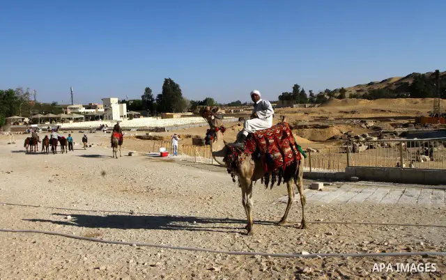 Foreign tourists ride Sentences near the Giza Pyramids at the outskirts of Cairo, capital of Egypt. in this picture taken May 11, 2011. Photo by Ashraf Amra