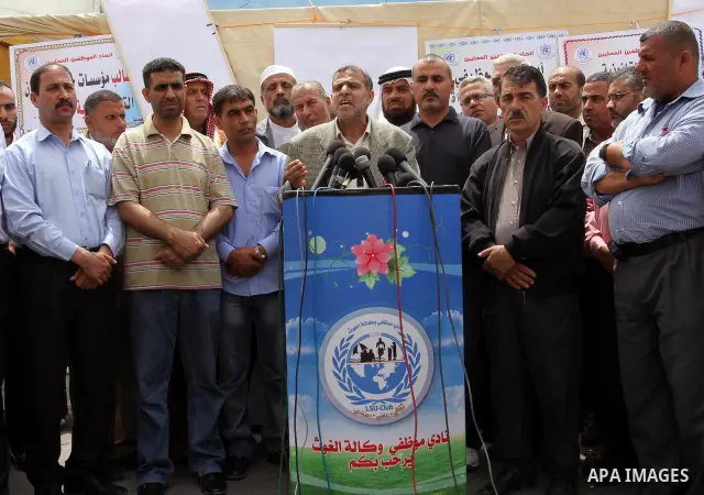 Palestinian employees strike and deliver a speach during a press conference in front of United Nations Relief and Works Agency (UNRWA) in Gaza City May 18, 2011. they as UN Palestinian employees stage a one day-strike de...