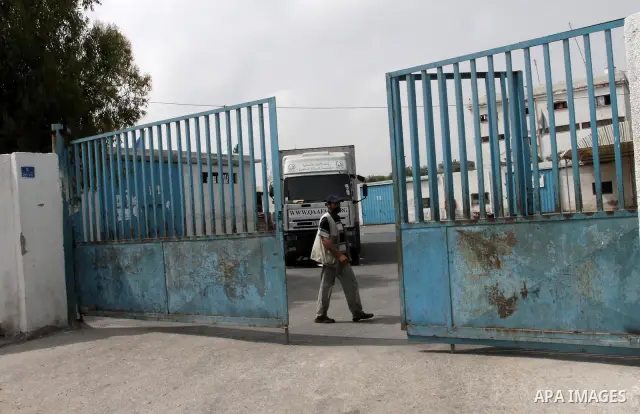 Palestinian man walks past a United Nations Relief and Works Agency (UNRWA) closed school in Gaza City May 18, 2011 as UN Palestinian employees stage a one day-strike demanding higher wages. Some 16 thousand Palestinians...