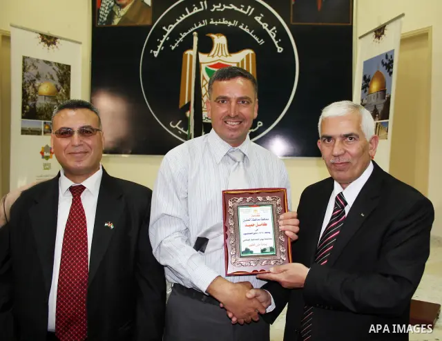 Palestinian Hebron governor, Kamel Hamed honors APAimages photojournalist Najeh Hashlamoun in occasion of Journalist Day at the Governorate of Hebron in the West Bank city of Hebron,on May18, 2011. Photo by Mamoun Wazwaz...