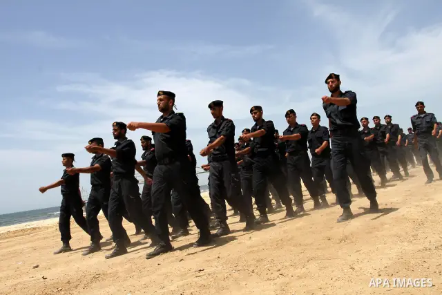Palestinian Hamas security forces march during a ceremony to honor the Palestinian policemen in Gaza city on May 19, 2011, in the occasion of recognition of the Palestinian Police College. Photo by Mohammed Asad