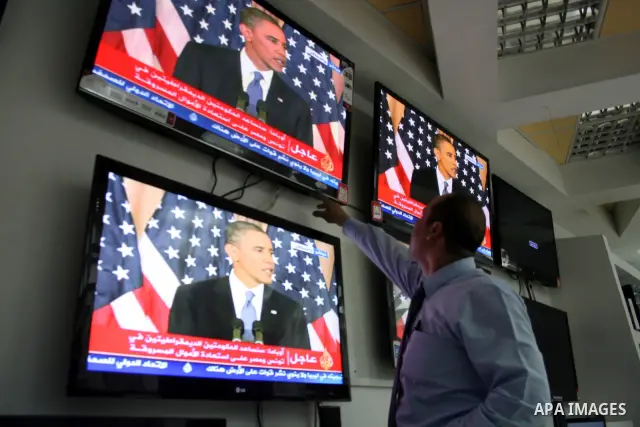 Palestinians watch TV in the West Bank city of Ramallah as the US President Barack Obama speaks on the events in the Middle East and North Africa at the State Department in Washington, DC, May 19, 2011. Obama said that t...