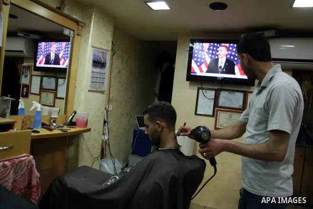 Palestinians watch TV in the West Bank city of Ramallah as the US President Barack Obama speaks on the events in the Middle East and North Africa at the State Department in Washington, DC, May 19, 2011. Obama said that t...