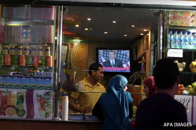Palestinians watch TV in the West Bank city of Ramallah as the US President Barack Obama speaks on the events in the Middle East and North Africa at the State Department in Washington, DC, May 19, 2011. Obama said that t...