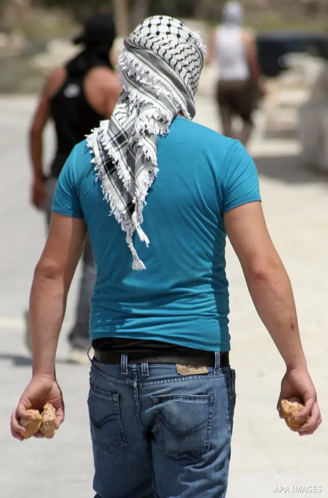 Masked Palestinian demonstrators hurl stones toward Israeli soldiers during a demonstration in the West Bank village of Al-khader near Bethlehem, Friday, May 20, 2011. President Barack Obama on Thursday finally uttered t...