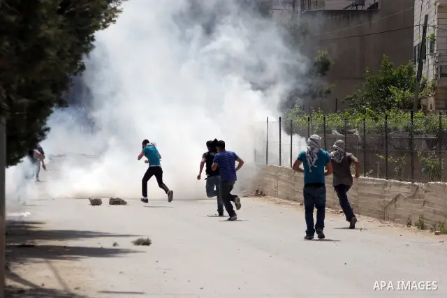 Masked Palestinian demonstrators hurl stones toward Israeli soldiers during a demonstration in the West Bank village of Al-khader near Bethlehem, Friday, May 20, 2011. President Barack Obama on Thursday finally uttered t...