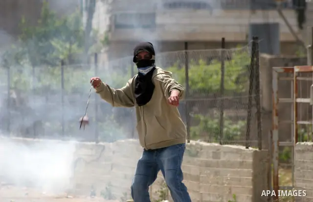 Masked Palestinian demonstrators hurl stones toward Israeli soldiers during a demonstration in the West Bank village of Al-khader near Bethlehem, Friday, May 20, 2011. President Barack Obama on Thursday finally uttered t...