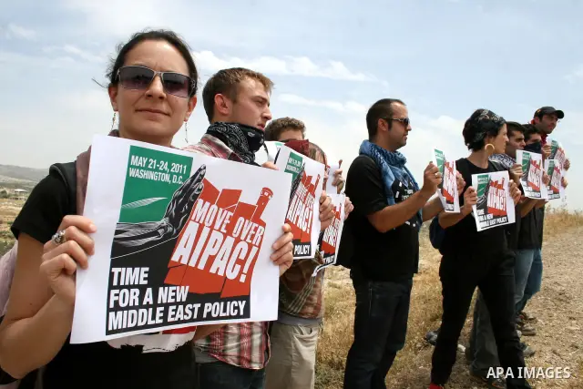 Foreign demonstrators hold banners during the weekly demonstration against Israel's separation barrier in the West Bank village of Bilin, near Ramallah, Friday, May 20, 2011. President Barack Obama on Thursday finally ut...