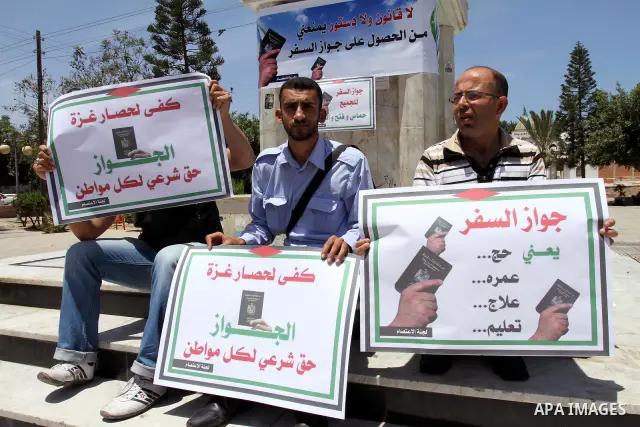 Palestinian protesters hold banners during an effectiveness to prevent them from obtaining passports by Ramallah, in Gaza city on May 21, 2011. Palestinians condemn it , and raise slogans against the political partisansh...